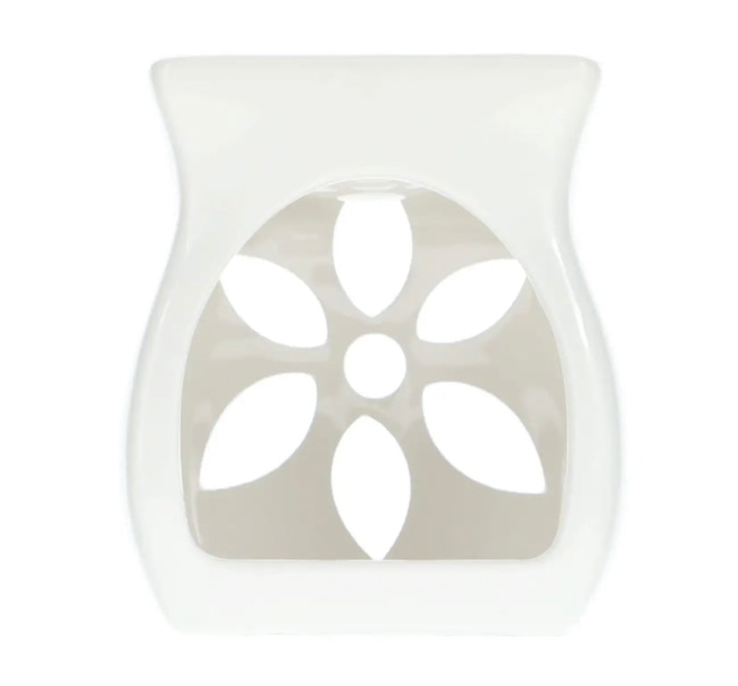 A white tea light candle warmer placed on a plain white background, highlighting the warmth of the scene, creating a cozy atmosphere.