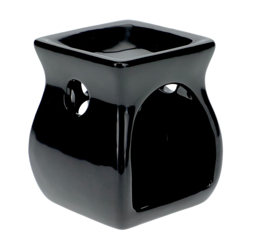 A black tea light candle warmer placed on a plain white background, offering a contrast to the deep color of the warmer.